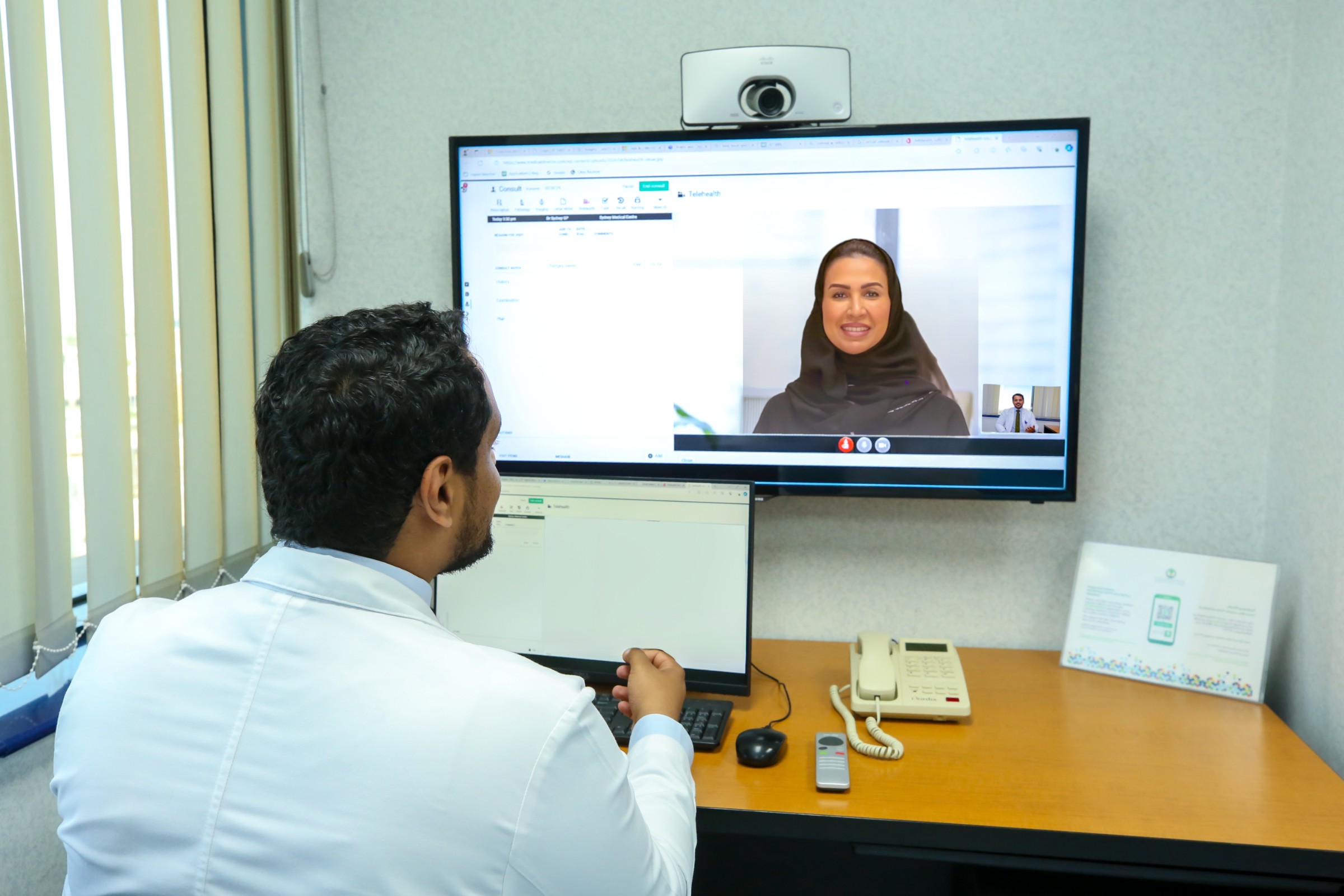A KFSH physician follows up with a patient remotely